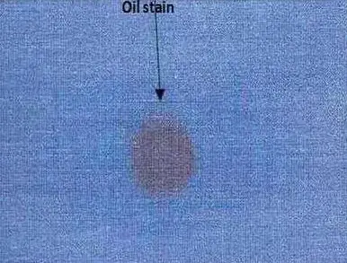 Oil spot or stain defect of woven fabric